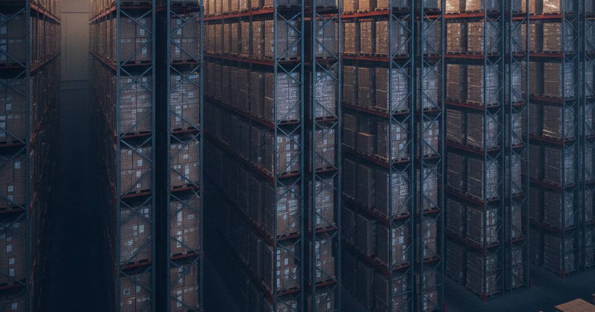 High-bay warehouse aisle under overhead light